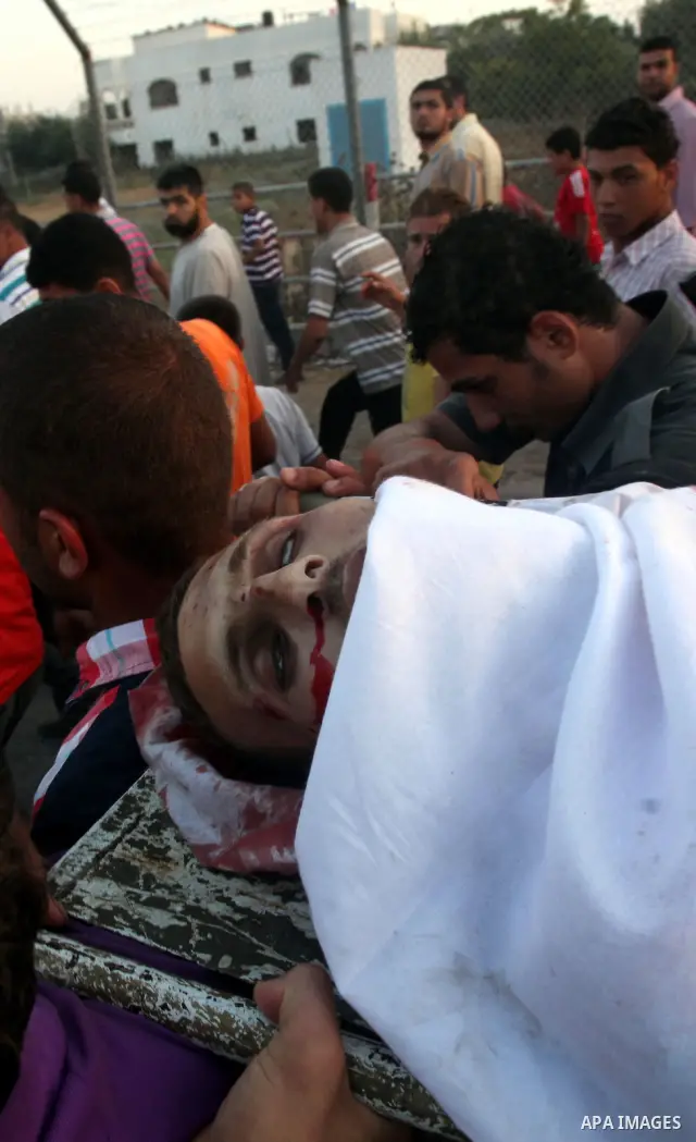 Palestinians carry the body of Abd El-Kareem Al-Za'aneen during his funeral after he was killed in an Israeli air strike near Beit Hanoun, northern Gaza Strip, Monday, June 18, 2012. The Israeli strike comes after killed...