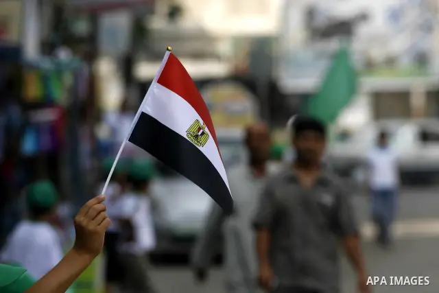 Palestinian boys supporter hold up Egyptian flags as they celebrate in Rafah, in the southern Gaza Strip, 19 June 2012. Egypt's Muslim Brotherhood claimed on 18 June 2012 victory in Egypt's first presidential election si...