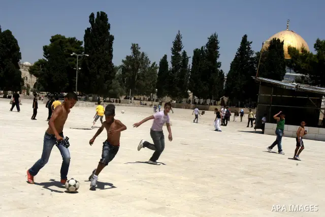 Palestinian children play foot ball during a participate in summer camps at Al-Aqsa mosque in the old city of Jerusalem on 19 June 2012. Photo by Mahfouz Abu Turk