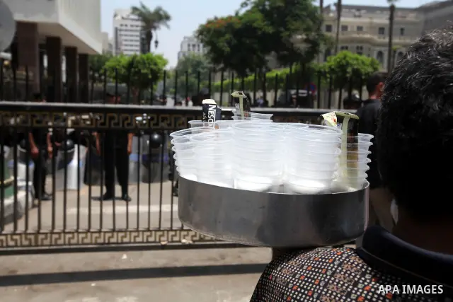 An Egyptian child sells drinks in front of riot police blocking the access to the street of the parliament in Cairo, Egypt, 09 June 2012. A new constitutional document issued by the Supreme Council of the Armed Forces (S...