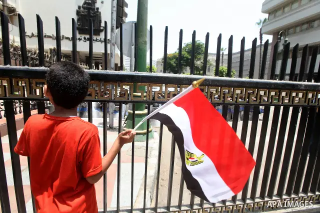 An Egyptian child stands in front of riot police blocking the access to the street of the parliament in Cairo, Egypt, 09 June 2012. A new constitutional document issued by the Supreme Council of the Armed Forces (SCAF),...