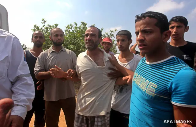 A relative of Palestinian Mohammed abu Maleg reacts after his body was recovered in Dir al-Balah in the central Gaza Strip June 19, 2012. An Israeli air strike killed two Palestinians, one of them abu Maleg, in the Gaza...