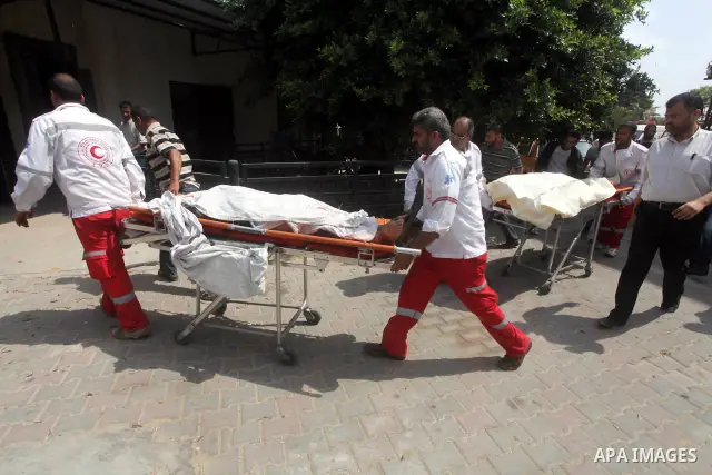 Palestinian medics transmit body of Palestinian Mohammed Abu Maleg to the hospital in Dir al-Balah in the central Gaza Strip June 19, 2012. An Israeli air strike killed two Palestinians, one of them abu Maleg, in the Gaz...