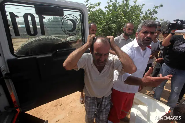 A relative of Palestinian Mohammed abu Maleg reacts after his body was recovered in Dir al-Balah in the central Gaza Strip June 19, 2012. An Israeli air strike killed two Palestinians, one of them abu Maleg, in the Gaza...