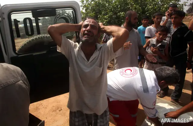 A relative of Palestinian Mohammed abu Maleg reacts after his body was recovered in Dir al-Balah in the central Gaza Strip June 19, 2012. An Israeli air strike killed two Palestinians, one of them abu Maleg, in the Gaza...