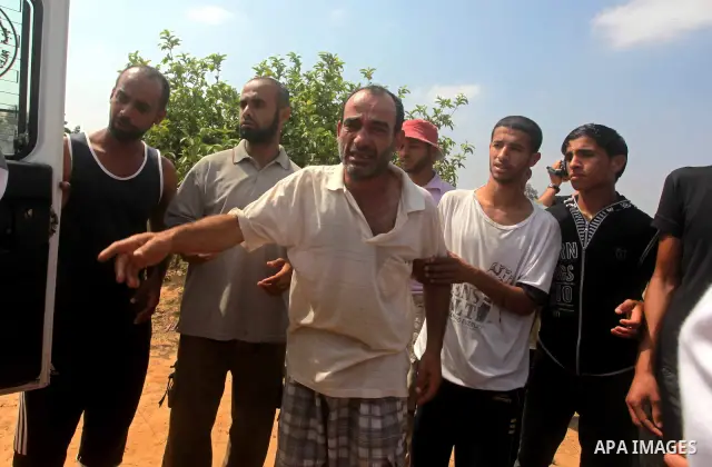 A relative of Palestinian Mohammed abu Maleg reacts after his body was recovered in Dir al-Balah in the central Gaza Strip June 19, 2012. An Israeli air strike killed two Palestinians, one of them abu Maleg, in the Gaza...