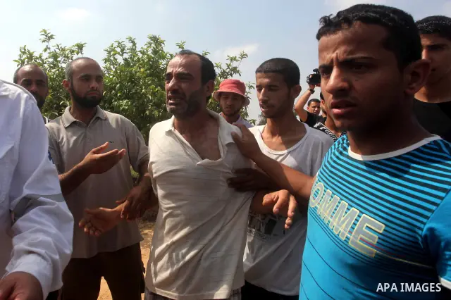 A relative of Palestinian Mohammed abu Maleg reacts after his body was recovered in Dir al-Balah in the central Gaza Strip June 19, 2012. An Israeli air strike killed two Palestinians, one of them abu Maleg, in the Gaza...