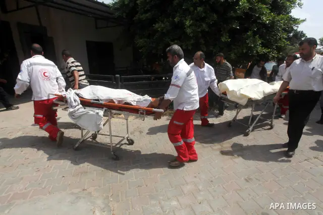 Palestinian medics transmit body of Palestinian Mohammed Abu Maleg to the hospital in Dir al-Balah in the central Gaza Strip June 19, 2012. An Israeli air strike killed two Palestinians, one of them abu Maleg, in the Gaz...