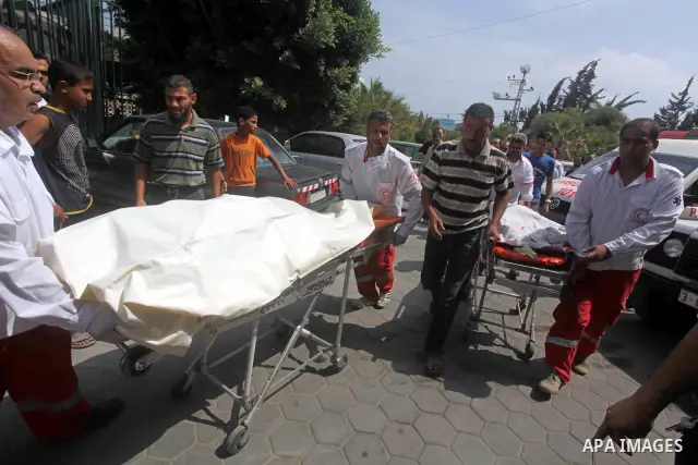 Palestinian medics transmit body of Palestinian Mohammed Abu Maleg to the hospital in Dir al-Balah in the central Gaza Strip June 19, 2012. An Israeli air strike killed two Palestinians, one of them abu Maleg, in the Gaz...