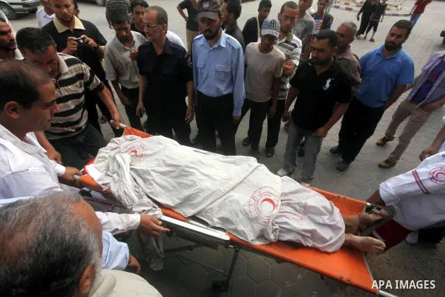 Palestinian medics transmit body of Palestinian Mohammed Abu Maleg to the hospital in Dir al-Balah in the central Gaza Strip June 19, 2012. An Israeli air strike killed two Palestinians, one of them abu Maleg, in the Gaz...