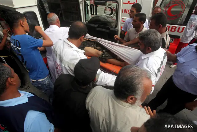 Palestinian medics transmit body of Palestinian Mohammed Abu Maleg to the hospital in Dir al-Balah in the central Gaza Strip June 19, 2012. An Israeli air strike killed two Palestinians, one of them abu Maleg, in the Gaz...