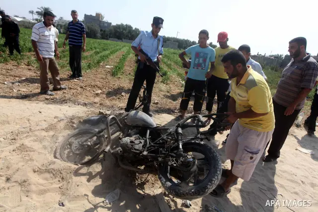 A Palestinian man checks a motorcycle that was hit in an Israeli air strike in Dir al-Balah in the central Gaza Strip June 19, 2012. An Israeli army statement said the Israeli air force targeted Palestinian militants in...