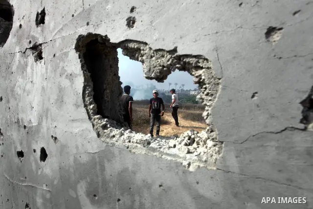 Palestinians inspect the place that was under an Israeli air strike in Dir al-Balah in the central Gaza Strip June 19, 2012. An Israeli army statement said the Israeli air force targeted Palestinian militants in the cent...