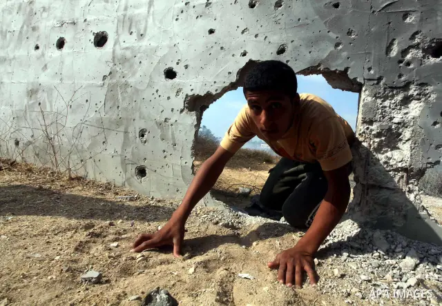 A Palestinian child inspects the place that was under an Israeli air strike in Dir al-Balah in the central Gaza Strip June 19, 2012. An Israeli army statement said the Israeli air force targeted Palestinian militants in...