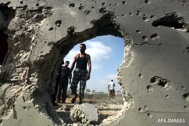 Palestinians inspect the place that was under an Israeli air strike in Dir al-Balah in the central Gaza Strip June 19, 2012. An Israeli army statement said the Israeli air force targeted Palestinian militants in the cent...