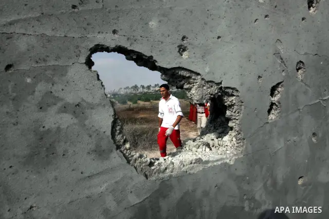 Palestinian medics inspect the place that was under an Israeli air strike in Dir al-Balah in the central Gaza Strip June 19, 2012. An Israeli army statement said the Israeli air force targeted Palestinian militants in th...
