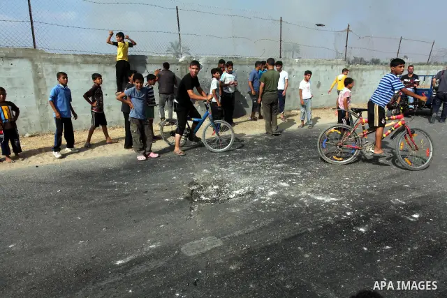 Palestinians inspect the place that was under an Israeli air strike in Dir al-Balah in the central Gaza Strip June 19, 2012. An Israeli army statement said the Israeli air force targeted Palestinian militants in the cent...