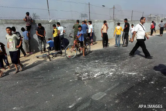 Palestinians inspect the place that was under an Israeli air strike in Dir al-Balah in the central Gaza Strip June 19, 2012. An Israeli army statement said the Israeli air force targeted Palestinian militants in the cent...