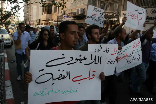 Palestinian demonstrators take part in a protest against the Lebanese army assault on Palestinian refugees in Nahr al-Bared refugee camp, killing some of them, in the West Bank city of Ramallah, on 19 June 2012. Photo by...
