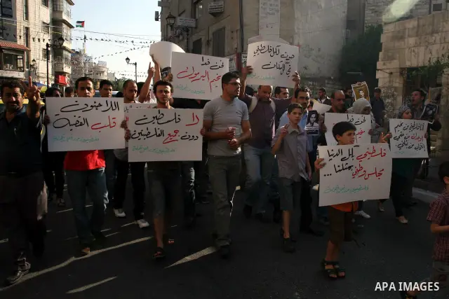 Palestinian demonstrators take part in a protest against the Lebanese army assault on Palestinian refugees in Nahr al-Bared refugee camp, killing some of them, in the West Bank city of Ramallah, on 19 June 2012. Photo by...