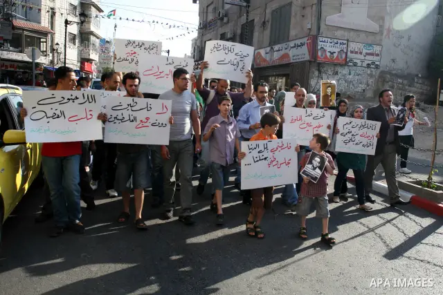 Palestinian demonstrators take part in a protest against the Lebanese army assault on Palestinian refugees in Nahr al-Bared refugee camp, killing some of them, in the West Bank city of Ramallah, on 19 June 2012. Photo by...