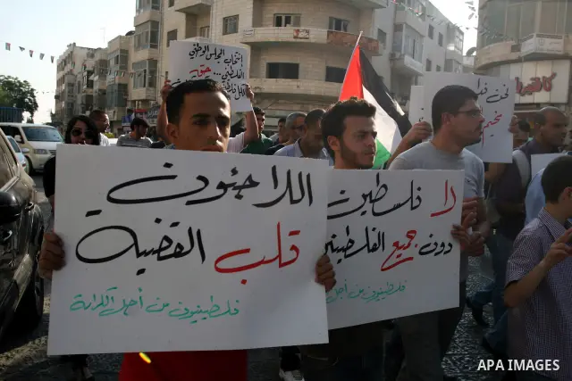 Palestinian demonstrators take part in a protest against the Lebanese army assault on Palestinian refugees in Nahr al-Bared refugee camp, killing some of them, in the West Bank city of Ramallah, on 19 June 2012. Photo by...