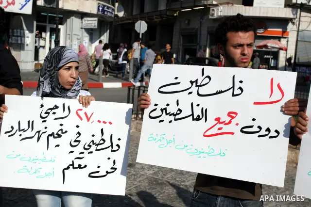Palestinian demonstrators take part in a protest against the Lebanese army assault on Palestinian refugees in Nahr al-Bared refugee camp, killing some of them, in the West Bank city of Ramallah, on 19 June 2012. Photo by...