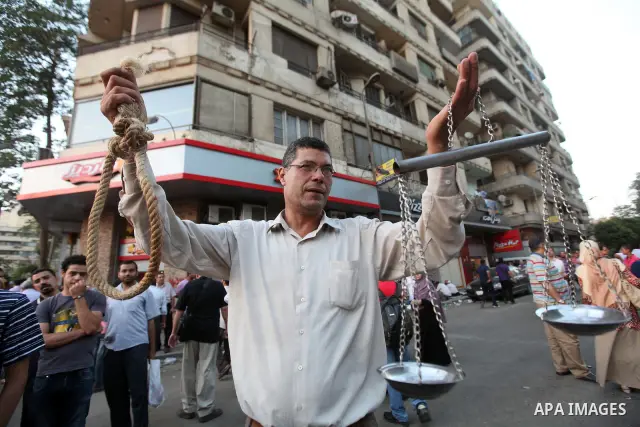 Egyptians protestors chat anti-Supreme Council for the Armed Forces as they stand guard during a protest against the military council outside Egypt's parliament in Cairo June 19, 2012. Egypt's Muslim Brotherhood declared...