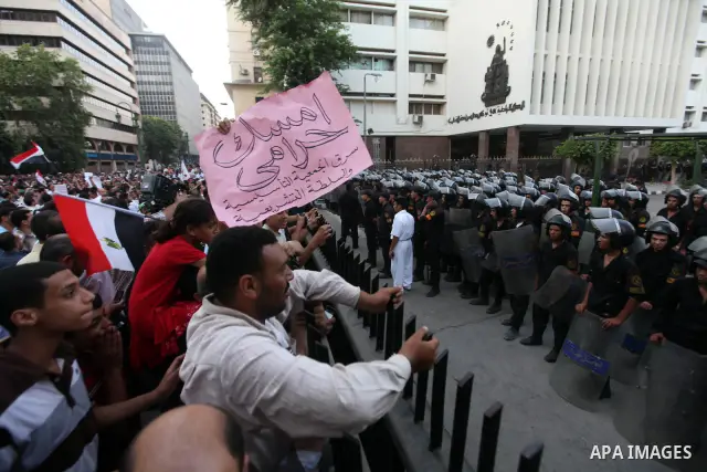 Egyptians protestors chat anti-Supreme Council for the Armed Forces as they stand guard during a protest against the military council outside Egypt's parliament in Cairo June 19, 2012. Egypt's Muslim Brotherhood declared...