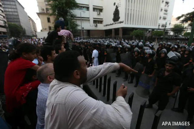 Egyptians protestors chat anti-Supreme Council for the Armed Forces as they stand guard during a protest against the military council outside Egypt's parliament in Cairo June 19, 2012. Egypt's Muslim Brotherhood declared...
