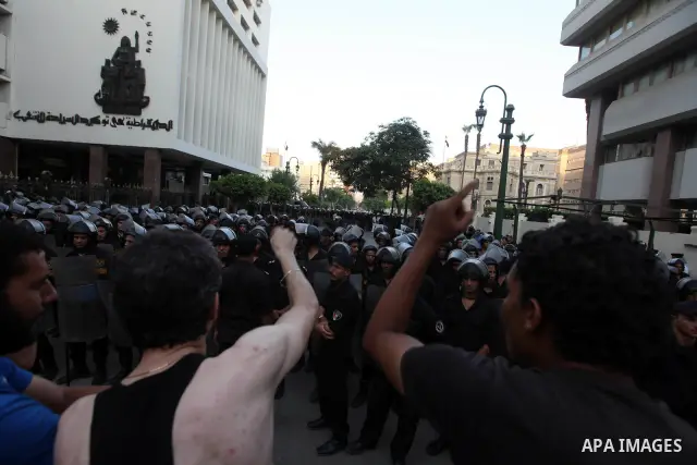 Egyptians protestors chat anti-Supreme Council for the Armed Forces as they stand guard during a protest against the military council outside Egypt's parliament in Cairo June 19, 2012. Egypt's Muslim Brotherhood declared...
