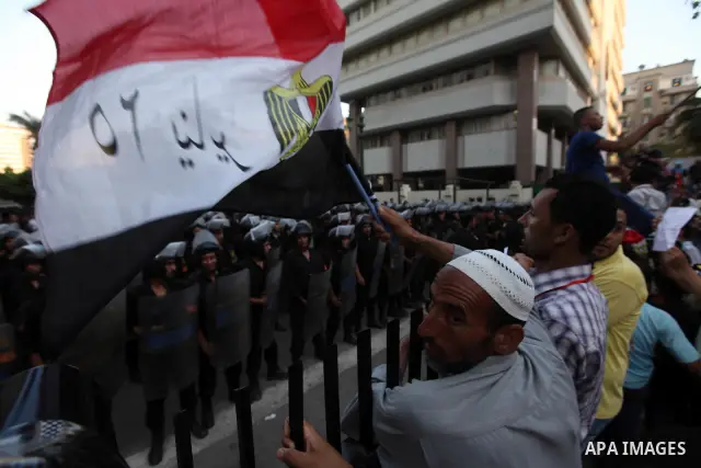 Egyptians protestors chat anti-Supreme Council for the Armed Forces as they stand guard during a protest against the military council outside Egypt's parliament in Cairo June 19, 2012. Egypt's Muslim Brotherhood declared...