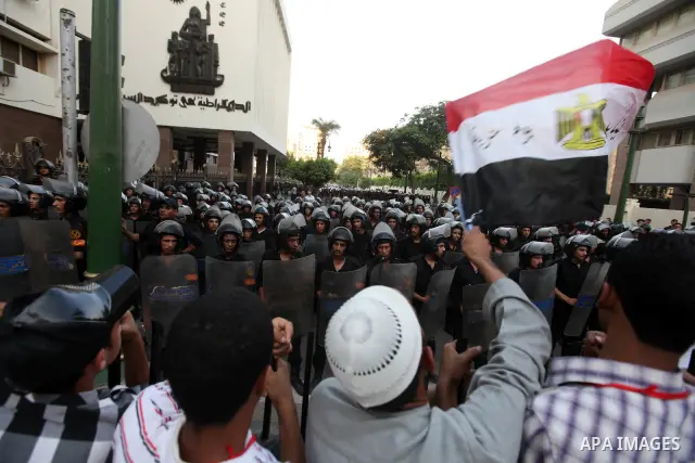 Egyptians protestors chat anti-Supreme Council for the Armed Forces as they stand guard during a protest against the military council outside Egypt's parliament in Cairo June 19, 2012. Egypt's Muslim Brotherhood declared...