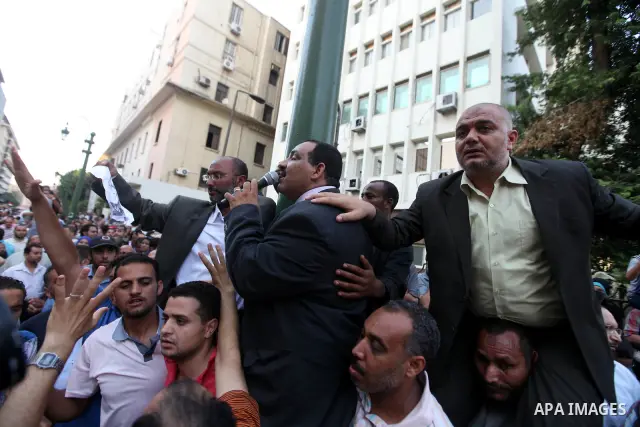 Egyptians protestors chat anti-Supreme Council for the Armed Forces as they stand guard during a protest against the military council outside Egypt's parliament in Cairo June 19, 2012. Egypt's Muslim Brotherhood declared...