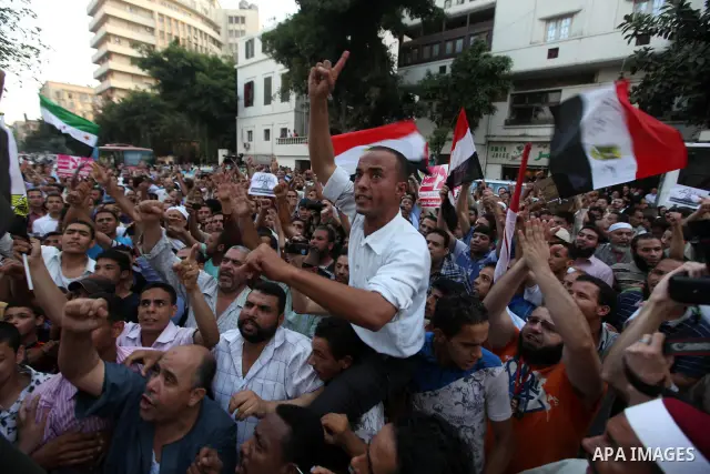 Egyptians protestors chat anti-Supreme Council for the Armed Forces as they stand guard during a protest against the military council outside Egypt's parliament in Cairo June 19, 2012. Egypt's Muslim Brotherhood declared...