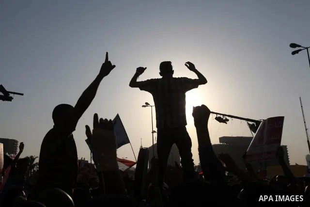 Egyptian supporters of Muslim Brotherhood presidential candidate Mohammed Mursi wave their national flag as they gather in Cairo's Tahrir Square on June 19, 2012 to protest against the ruling military's bid to grab new p...
