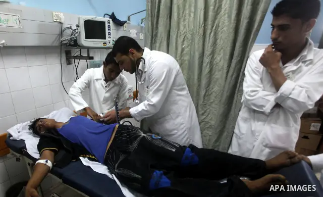 Palestinian medics transmit palestinian man to the hospital in Dir al-Balah in the central Gaza Strip June 20, 2012. The Israeli military said it had struck militant sites on Wednesday in retaliation to rocket fire into...