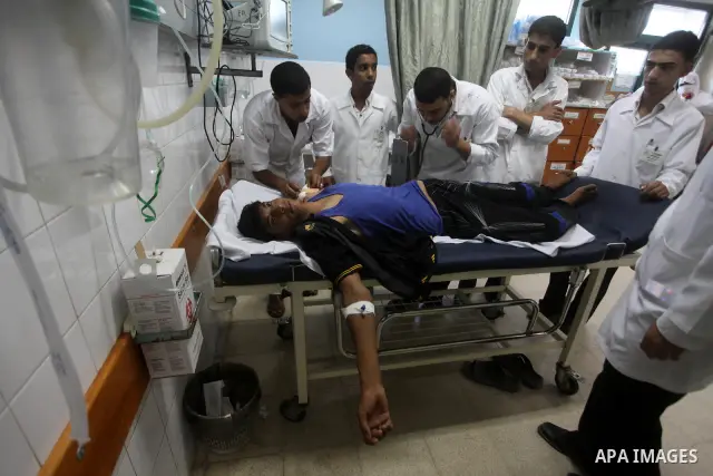 Palestinian medics transmit palestinian man to the hospital in Dir al-Balah in the central Gaza Strip June 20, 2012. The Israeli military said it had struck militant sites on Wednesday in retaliation to rocket fire into...