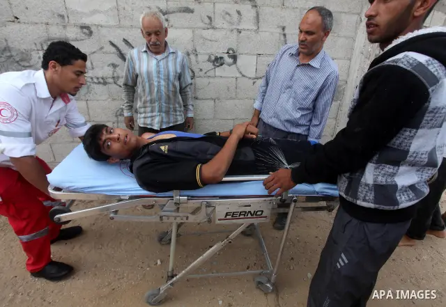 Palestinian medics transmit palestinian man to the hospital in Dir al-Balah in the central Gaza Strip June 20, 2012. The Israeli military said it had struck militant sites on Wednesday in retaliation to rocket fire into...