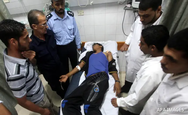Palestinian medics transmit palestinian man to the hospital in Dir al-Balah in the central Gaza Strip June 20, 2012. The Israeli military said it had struck militant sites on Wednesday in retaliation to rocket fire into...