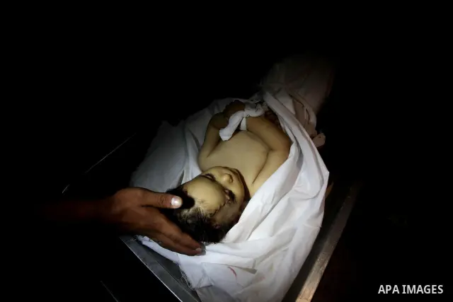 A Palestinian looks at the body of two-year-old girl, Hadeel al-Hadad, at the morgue in the al-Shifa hospital in Gaza City on June 20, 2012. There was no let-up in rocket fire from Gaza with at least 10 hitting the Jewis...