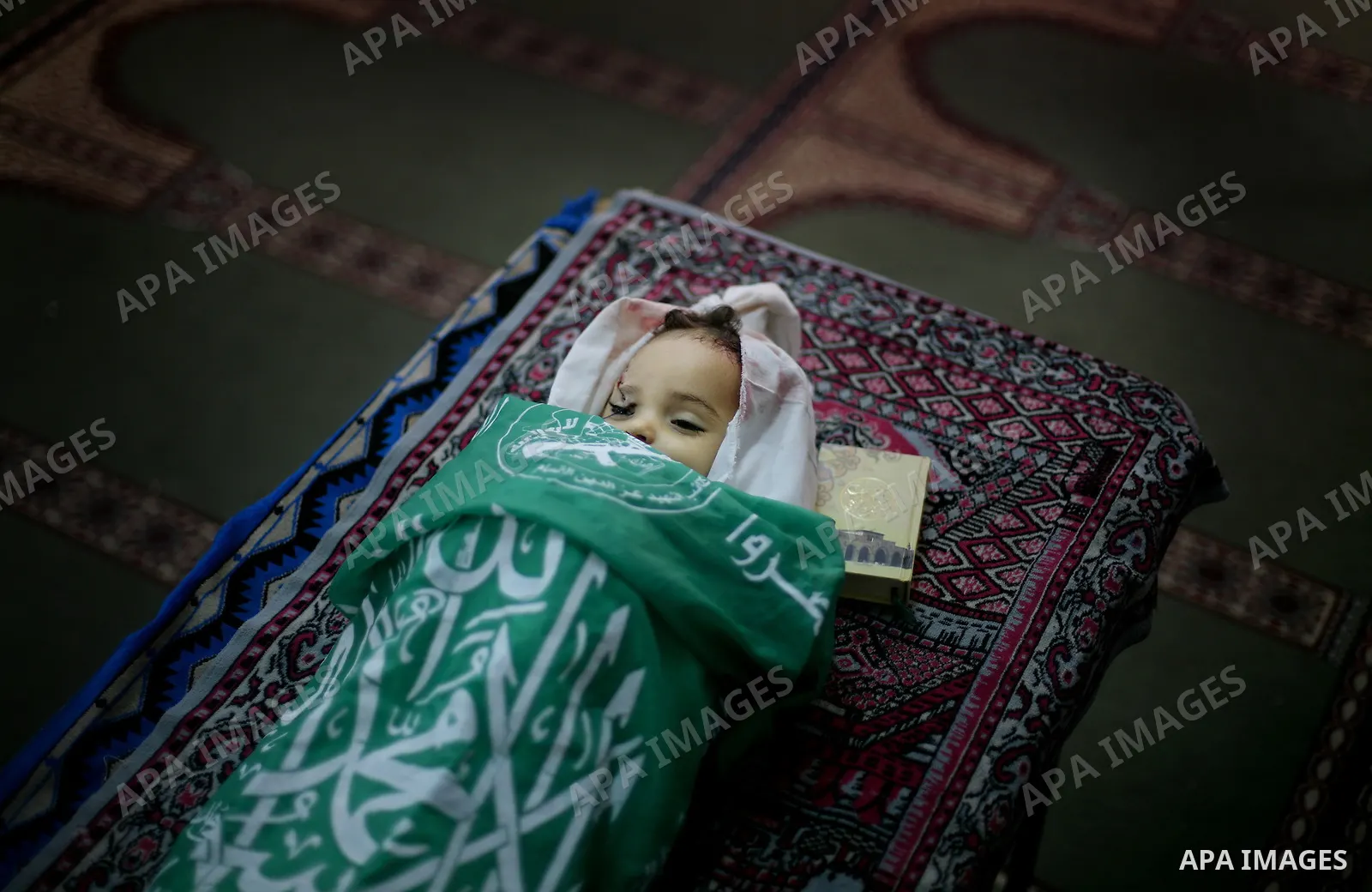Palestinian mourners pray over the body of Hadeel al-Hadad during her funeral in Gaza City on 20 June 2012. Hadeel was killed June 19 when Palestinian militants launched a rocket from Gaza City, which failed to reach its...