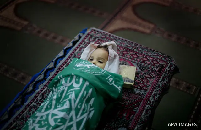 Palestinian mourners pray over the body of Hadeel al-Hadad during her funeral in Gaza City on 20 June 2012. Hadeel was killed June 19 when Palestinian militants launched a rocket from Gaza City, which failed to reach its...