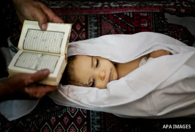 Palestinian mourners pray over the body of Hadeel al-Hadad during her funeral in Gaza City on 20 June 2012. Hadeel was killed June 19 when Palestinian militants launched a rocket from Gaza City, which failed to reach its...