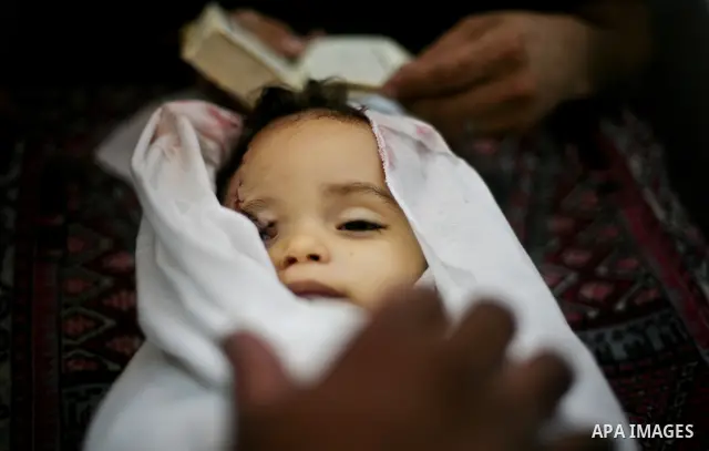 Palestinian mourners pray over the body of Hadeel al-Hadad during her funeral in Gaza City on 20 June 2012. Hadeel was killed June 19 when Palestinian militants launched a rocket from Gaza City, which failed to reach its...