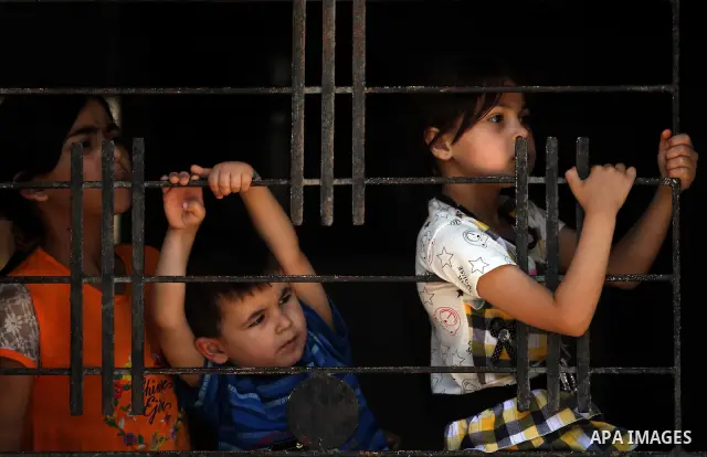 Palestinian children watch the funeral of Hadeel al-Hadad in Gaza City June 20, 2012. The two-year-old Gazan girl died and her brother was wounded when militants launched a rocket close by, Palestinian witnesses said. An...