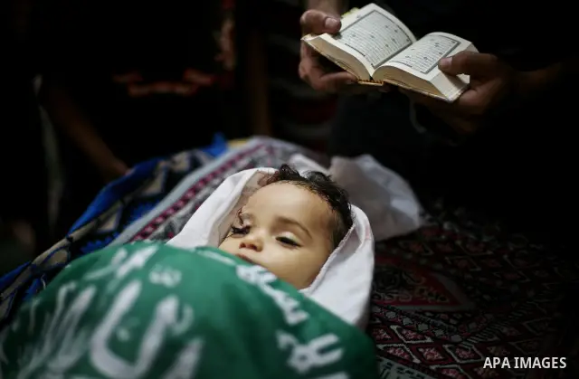 Palestinian mourners pray over the body of Hadeel al-Hadad during her funeral in Gaza City on 20 June 2012. Hadeel was killed June 19 when Palestinian militants launched a rocket from Gaza City, which failed to reach its...
