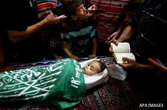 Palestinian mourners pray over the body of Hadeel al-Hadad during her funeral in Gaza City on 20 June 2012. Hadeel was killed June 19 when Palestinian militants launched a rocket from Gaza City, which failed to reach its...
