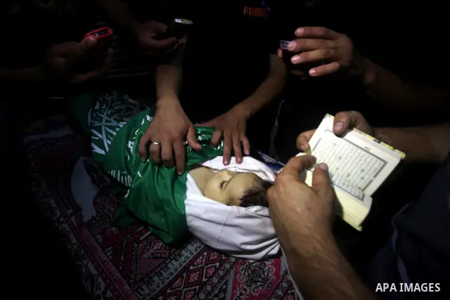 Palestinian mourners pray over the body of Hadeel al-Hadad during her funeral in Gaza City on 20 June 2012. Hadeel was killed June 19 when Palestinian militants launched a rocket from Gaza City, which failed to reach its...