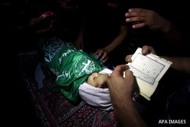 Palestinian mourners pray over the body of Hadeel al-Hadad during her funeral in Gaza City on 20 June 2012. Hadeel was killed June 19 when Palestinian militants launched a rocket from Gaza City, which failed to reach its...